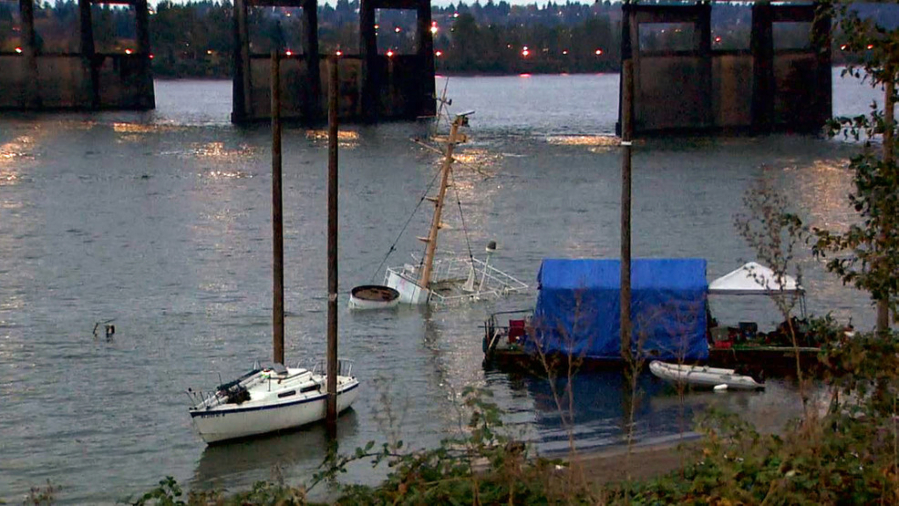 The Alert, an abandoned former Coast Guard vessel, sits on the bottom of the Columbia River downstream from the Interstate 5 Bridge in Portland after it sank Sunday evening.
