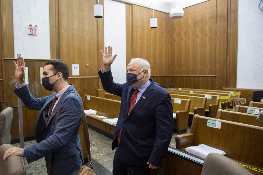 Attorney Evan Bariault, left, and plaintiff Don Benton thank the court staff as they leave the courtroom after hearing the favorable verdict in their lawsuit against Clark County.