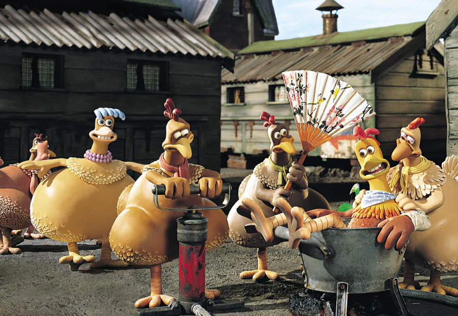 Rocky the rooster, voiced by Mel Gibson, is pampered by the hens at Tweedy's Egg Farm in the 2000 clay animation comedy "Chicken Run." (DreamWorks/Hulton Archive)