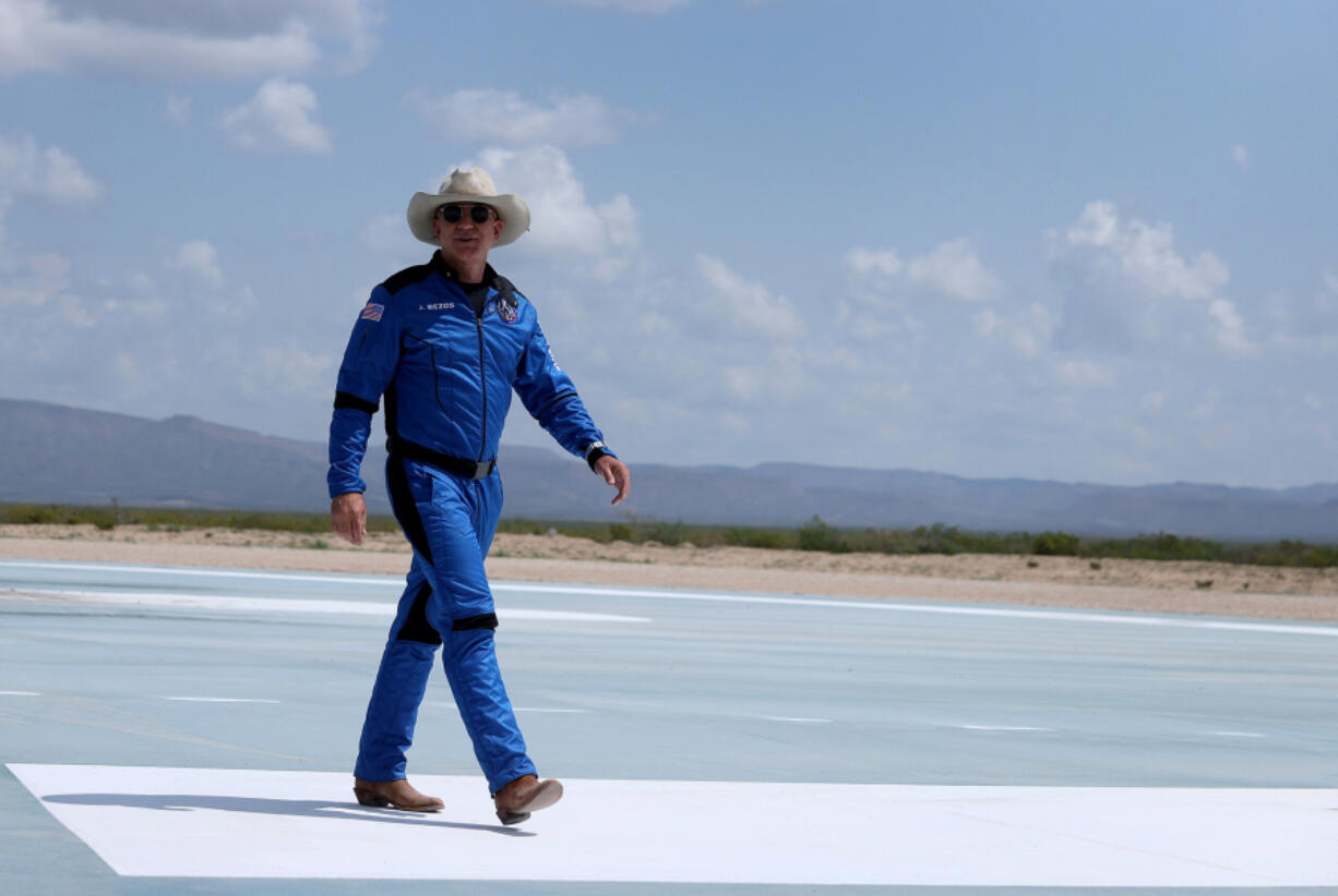 In this photo from July 20, 2021, Jeff Bezos walks near Blue Origin???s New Shepard after flying into space in Van Horn, Texas. In President Joe Biden's tax framework, the vast majority of the top 1% might get a tax cut.