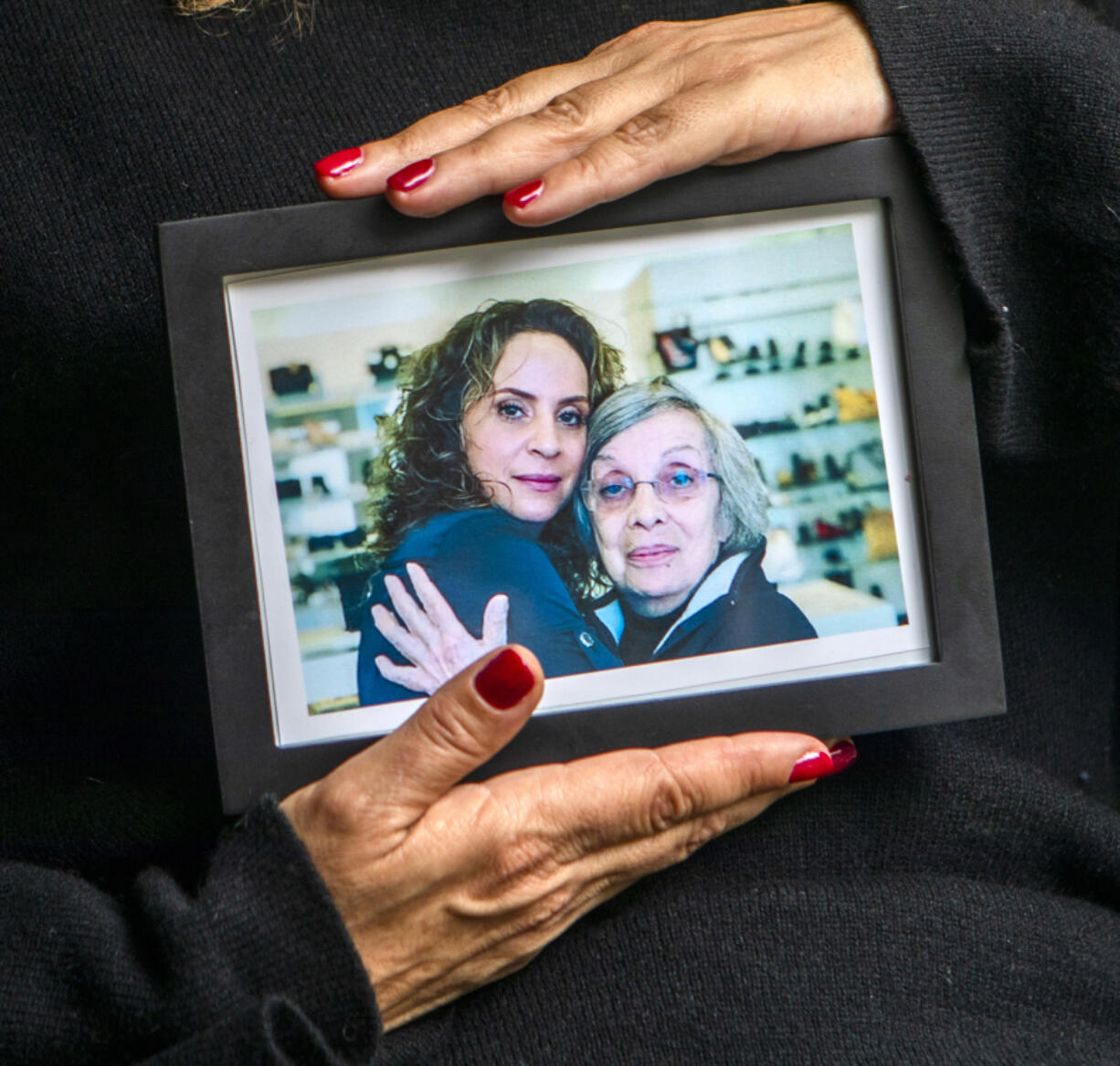 Helena Apothaker holds a photograph of her and her mother, Catherine, in West Hollywood. Apothaker is suing Silverado Senior Living after her mom died of COVID-19 at a care facility near Los Angeles' Fairfax District.