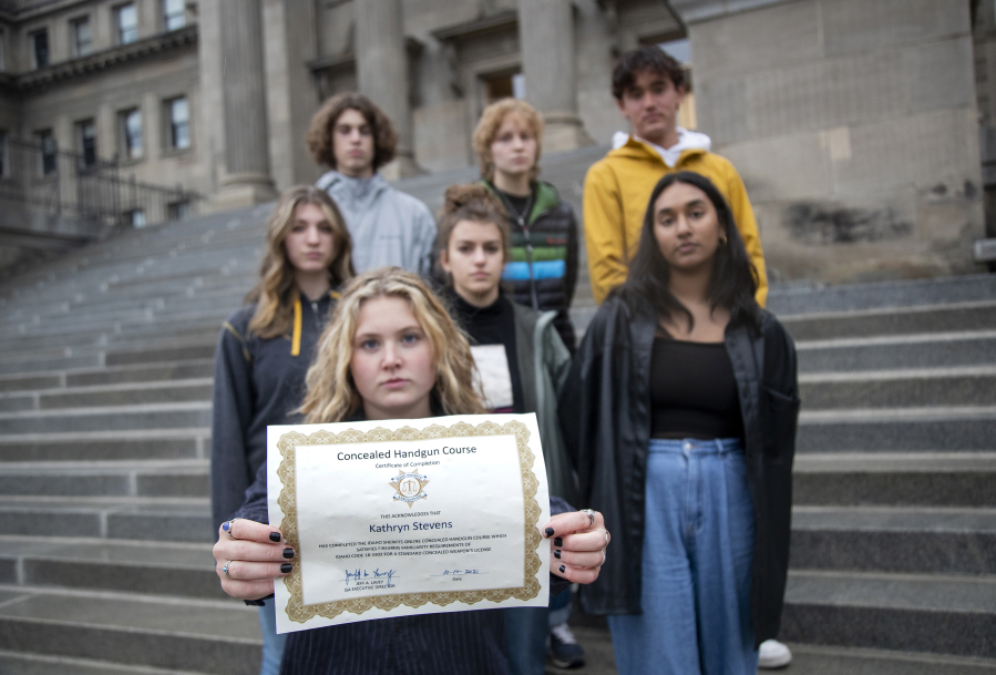 Boise High School senior Kate Stevens holds her certificate for online training for concealed carry as she stands with other student board members of the anti-gun violence group March for Our Lives on the steps of the Idaho Capital. The board is drafting gun control legislation to require licensing for minors. (Sarah A.