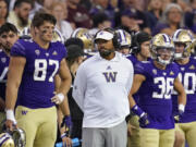 Washington head coach Jimmy Lake, center, reacts near the end of his team's season-opening loss to Montana. The Huskies began the season ranked in the Associated Press Top 25, but it wasn't long before things went awry.