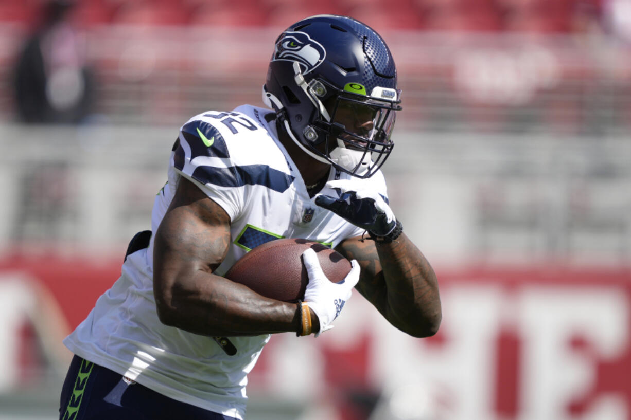 Seattle Seahawks running back Chris Carson warms up before an NFL football game against the San Francisco 49ers in Santa Clara, Calif., Sunday, Oct. 3, 2021.