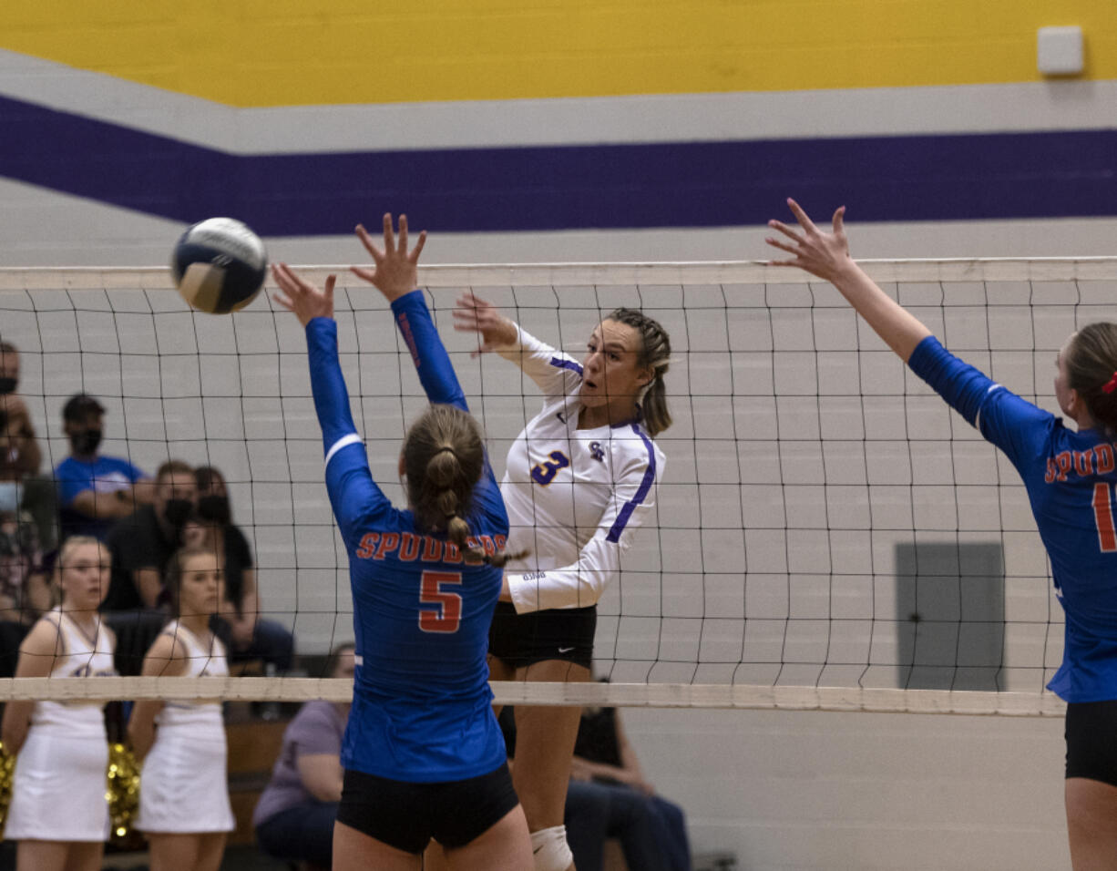 Columbia River?s Rylie Reeves hits it past the block of Ridgefield?s Natalie Andrew during a 2A Greater St. Helens League volleyball match on Tuesday, Sept. 21, 2021, at Columbia River High School. Ridgefield won 3-0.