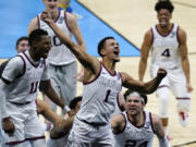 Gonzaga guard Jalen Suggs (1) celebrates making a 40-foot game-winning basket against UCLA during overtime in a Final Four semifinal game in Indianapolis.