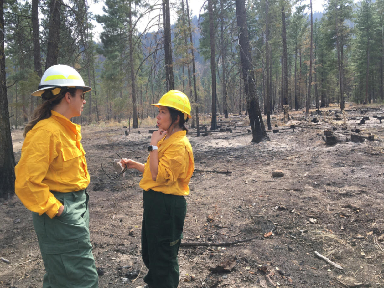 State Public Lands Commissioner Hilary Franz speaks with Twisp Mayor Soo Ing-Moody during an August tour of an area burned by the Cedar Creek Wildfire near the Methow Valley in Central Washington.