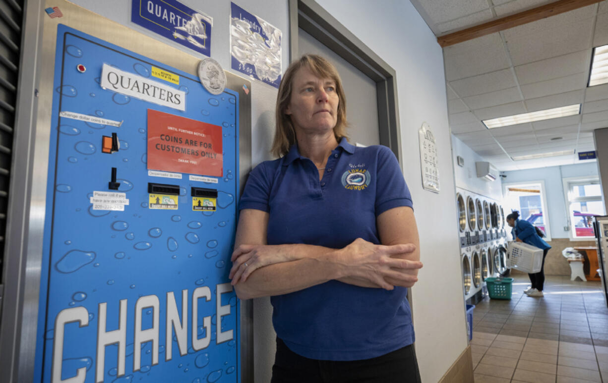 Heidi Thorsen, owner of Lunar Laundry in Seattle's Ballard neighborhood and shown Nov. 17, is dealing with a shortage of quarters at her laundromat. (Ellen M.