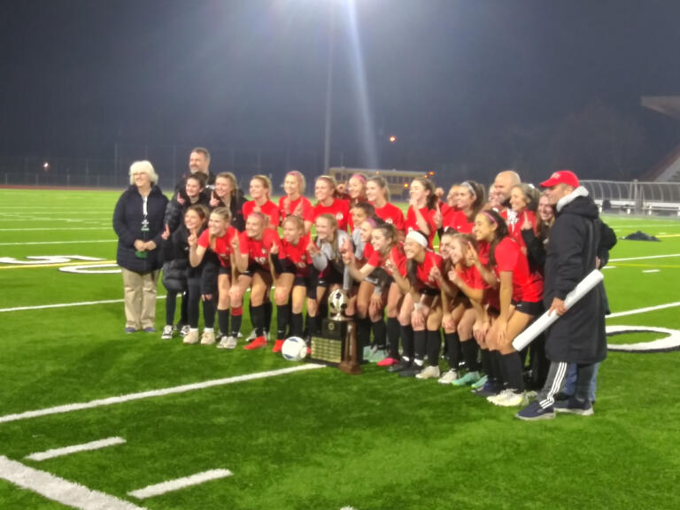 The Camas girls soccer team poses for a team photo after beating Issaquah 1-0 in overtime on penalty kicks to claim the 4A state title in Puyallup (Tim Martinez/The Columbian)