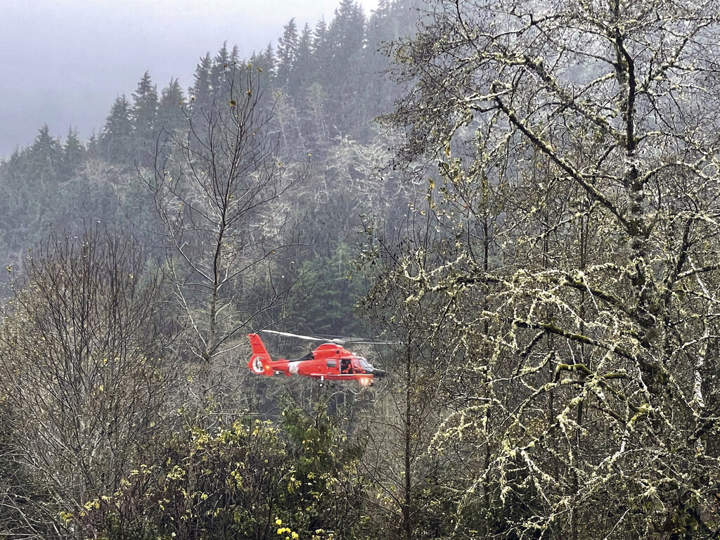 An air unit with the U.S. Coast Guard rescues trapped people from an RV park near Neskowin, Ore., on Friday, Nov. 12, 2021. The U.S. Coast Guard has used two helicopters to rescue about 50 people from rising waters at an RV park on the Oregon Coast Friday as heavy rains in the Pacific Northwest prompted warnings of floods and landslides.