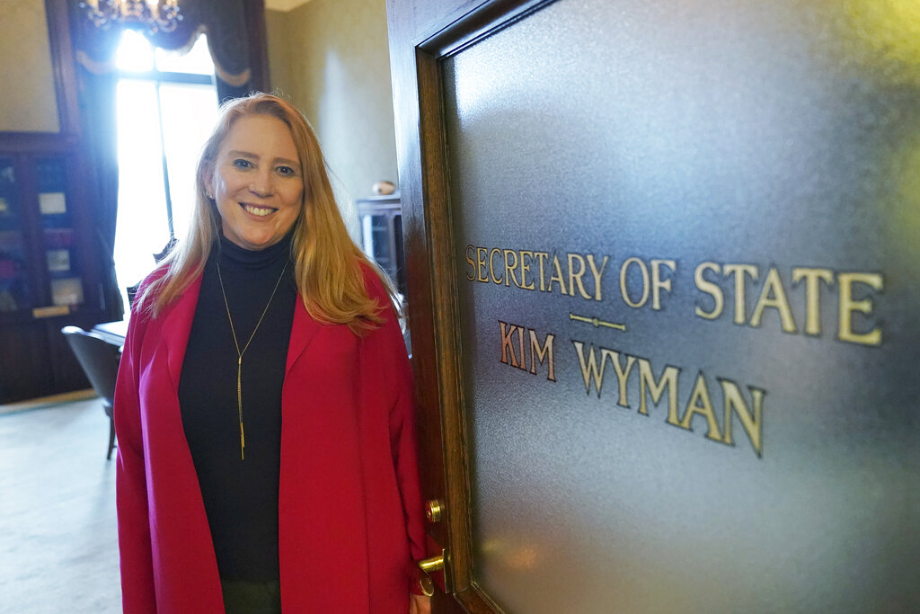 Washington Secretary of State Kim Wyman poses for a photo at the entrance to her office, Monday, Nov. 15, 2021, at the Capitol in Olympia, Wash. Wyman, a Republican, is leaving her office to serve as the election security lead for the Biden administration's Department of Homeland Security's Cybersecurity and Infrastructure Security Agency, the agency responsible for safeguarding U.S. elections. (AP Photo/Ted S.