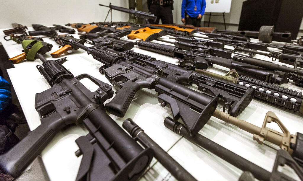 FILE - In this Dec. 27, 2012, file photo, a variety of military-style semi-automatic rifles obtained during a buy back program are displayed at Los Angeles police headquarters. The 9th U.S. Circuit Court of Appeals overturned two lower court judges and upheld California’s ban on high-capacity magazines Tuesday, Nov. 30, 2021, in a split decision that may be headed for the U.S. Supreme Court.