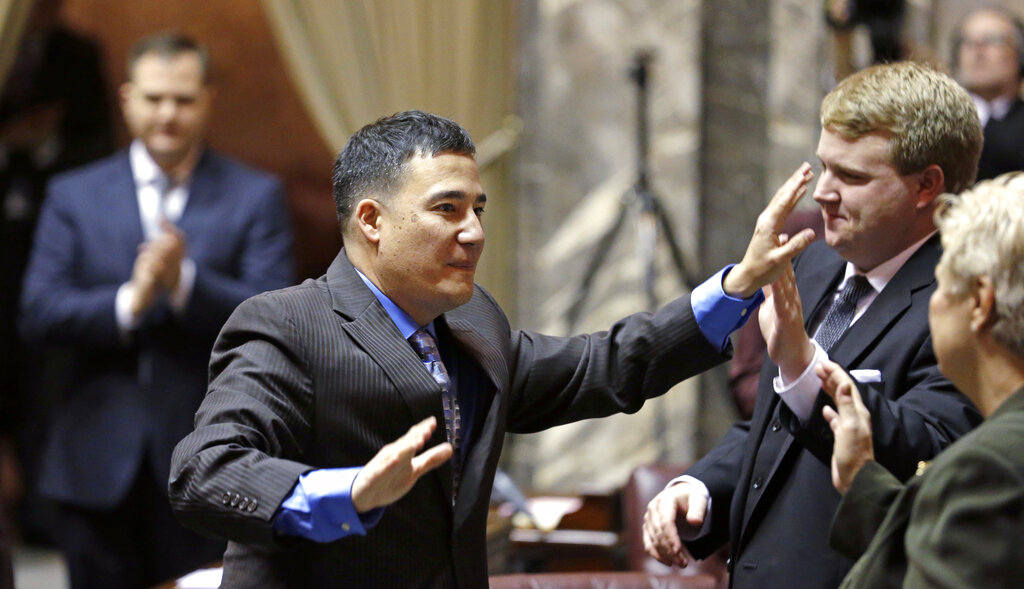 Then Sen. Steve Hobbs, D-Lake Stevens, gives high-fives as he enters the Senate chambers at the start of the 2015 legislative session in Olympia. Hobbs has been appointed Washington secretary of state by Gov. Jay Inslee, to replace Kim Wyman.