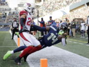 Seattle Seahawks wide receiver DK Metcalf (14) holds onto the ball for a catch but is ruled out of bounds as Arizona Cardinals' Marco Wilson defends during the first half of an NFL football game, Sunday, Nov. 21, 2021, in Seattle.