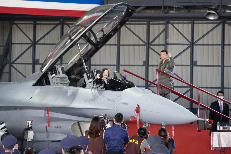 Taiwan's President Tsai Ing-wen poses for photos from the cockpit during a ceremony to commission into service 64 upgraded F-16V fighter jets at an Air Force base in Chiayi in southwestern Taiwan Thursday, Nov. 18, 2021. Taiwan has deployed the most advanced version of the F-16 fighter jet in its Air Force, as the island steps up its defense capabilities in the face of continuing threats from China.