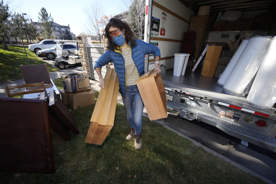 Team Rubicon volunteer Kaitlan Mahoney of Denver moves belongings into an apartment that will be home to Afghan refugees Wednesday, Nov. 10, 2021, in the north Denver suburb of Thornton, Colo. The team assembled furniture, washed dishes, lugged heavy couches and dressers up stairs and carefully placed donated backpacks and stuffed animals on children's beds.