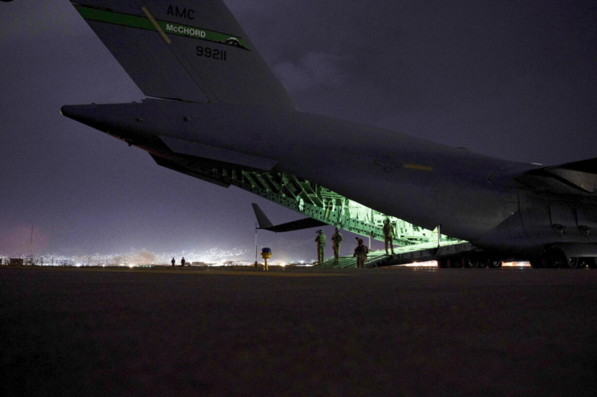 FILE - In this photo provided by the U.S. Air Force, an Air Force aircrew, assigned to the 816th Expeditionary Airlift Squadron, prepares to receive soldiers, assigned to the 82nd Airborne Division, to board a U.S. Air Force C-17 Globemaster III aircraft in support of the final noncombatant evacuation operation missions at Hamid Karzai International Airport in Kabul, Afghanistan on Aug. 30, 2021. The U.S. airlifted 124,000 people out of Kabul over about six weeks as the American-backed Afghan military and government fell to the Taliban. (Senior Airman Taylor Crul/U.S.
