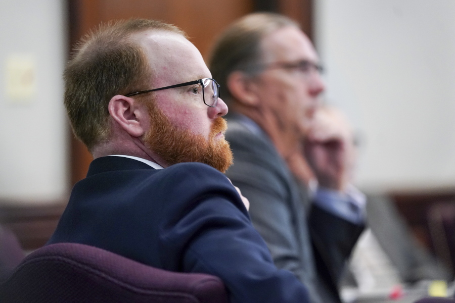 Defendant Travis McMichael listens to testimony during the trial for the killing of Ahmaud Arbery at the Glynn County Courthouse on Thursday, Nov. 18, 2021, in Brunswick, Ga.  Greg McMichael, his son Travis, and neighbor William "Roddie" Bryan are charged with the February 2020 slaying of 25-year-old Ahmaud Arbery.