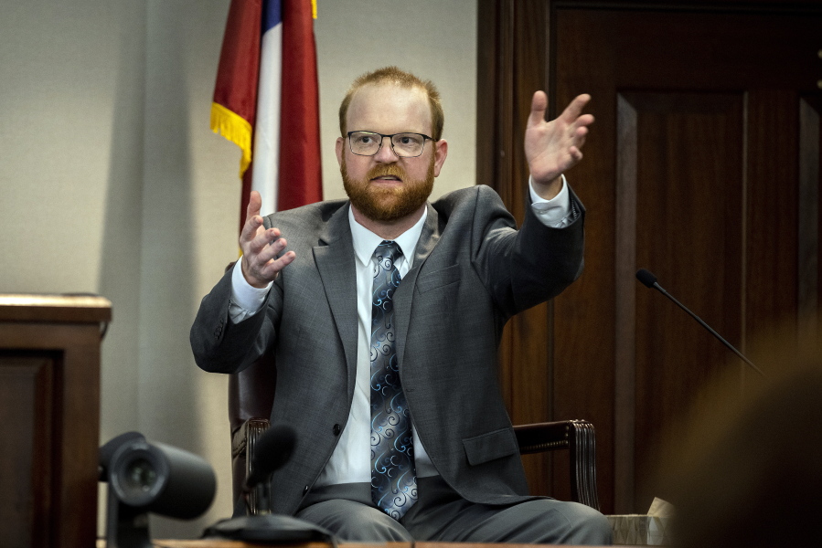 Travis McMichael speaks from the witness stand during his trial Wednesday, Nov. 17, 2021, in Brunswick, Ga. McMichael, his father Greg McMichael and their neighbor, William "Roddie" Bryan, are charged with the February 2020 death of 25-year-old Ahmaud Arbery. (AP Photo/Stephen B.