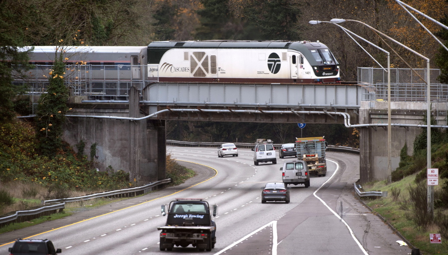The northbound Amtrak Cascades train rolls across the Interstate 5 overpass in DuPont, Wash., on Thursday, Nov. 18, 2021. The overpass was the site of the fatal train derailment in December 2018.