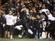 Oregon State linebacker Jack Colletto (12) is chased by Arizona State defensive back Chase Lucas (24) as he heads to the end zone after taking an offensive snap on fourth down in the fourth quarter of an NCAA college football game Saturday, Nov. 20, 2021, in Corvallis, Ore.