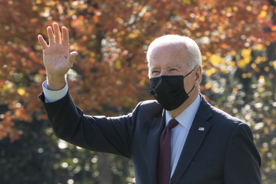 President Joe Biden waves towards the White House balcony as he leaves the White House, Wednesday, Nov. 17, 2021 in Washington, to visit General Motors' electric vehicle assembly plant in Detroit.