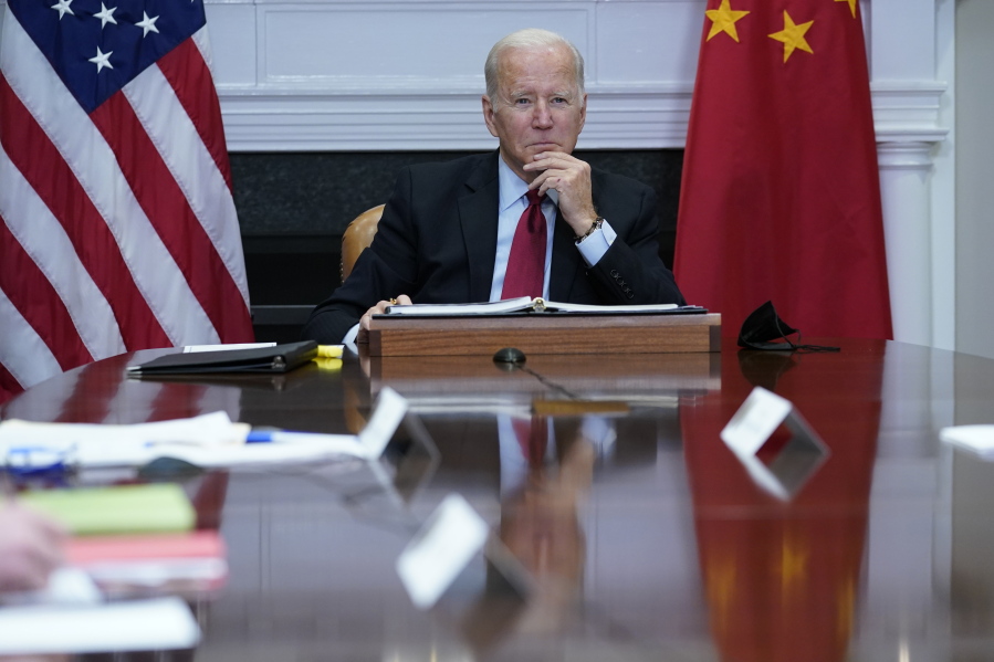 President Joe Biden listens as he meets virtually with Chinese President Xi Jinping from the Roosevelt Room of the White House in Washington, Monday, Nov. 15, 2021.