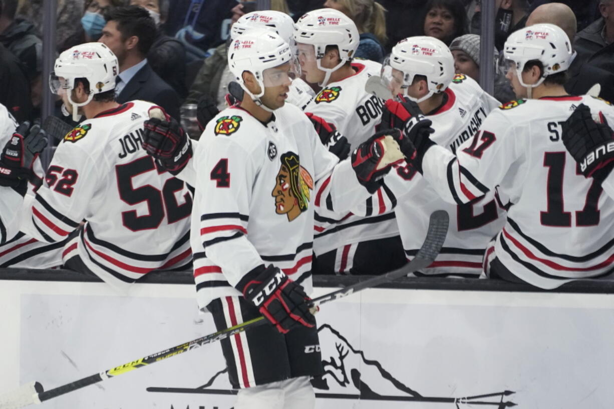 Chicago Blackhawks defenseman Seth Jones (4) greets teammates after he scored a goal against the Seattle Kraken during the first period of an NHL hockey game, Wednesday, Nov. 17, 2021, in Seattle. (AP Photo/Ted S.
