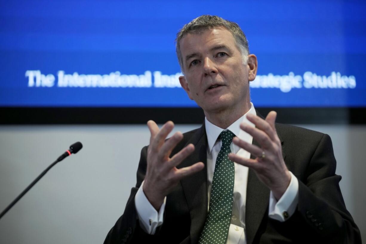 Richard Moore, the Chief of Britain's Secret Intelligence Service, also known as MI6, answers questions after giving his first public speech since becoming head of the organisation, at the International Institute for Strategic Studies, in London, Tuesday, Nov. 30, 2021. China, Russia and Iran pose three of the biggest threats to the U.K. in a fast-changing, unstable world, the head of Britain's foreign intelligence agency said Tuesday.