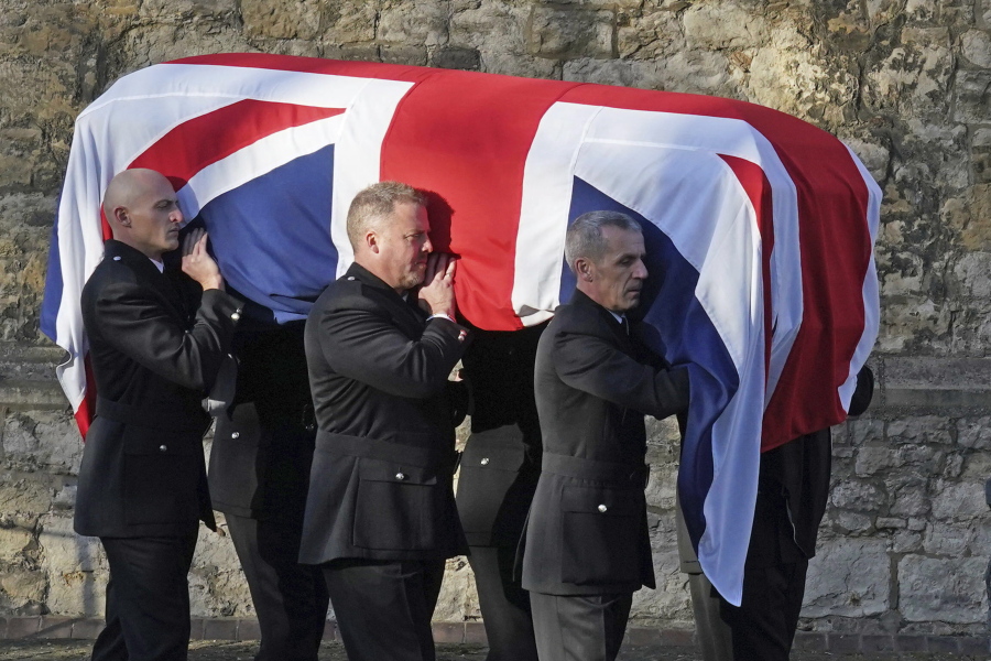 Pall bearers carry the coffin of Sir David Amess, the Conservative lawmaker stabbed to death as he met constituents at a church hall in Leigh-on-Sea in Essex on Oct. 15, out of St. Mary's Church in Prittlewell, Southend, England, Monday, Nov. 22, 2021 following his funeral service.