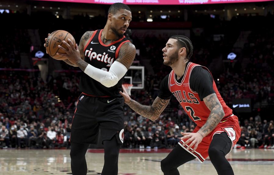Portland Trail Blazers guard Damian Lillard, left, looks to drive to the basket past Chicago Bulls guard Lonzo Ball during the first half of an NBA basketball game in Portland, Ore., Wednesday, Nov. 17, 2021.