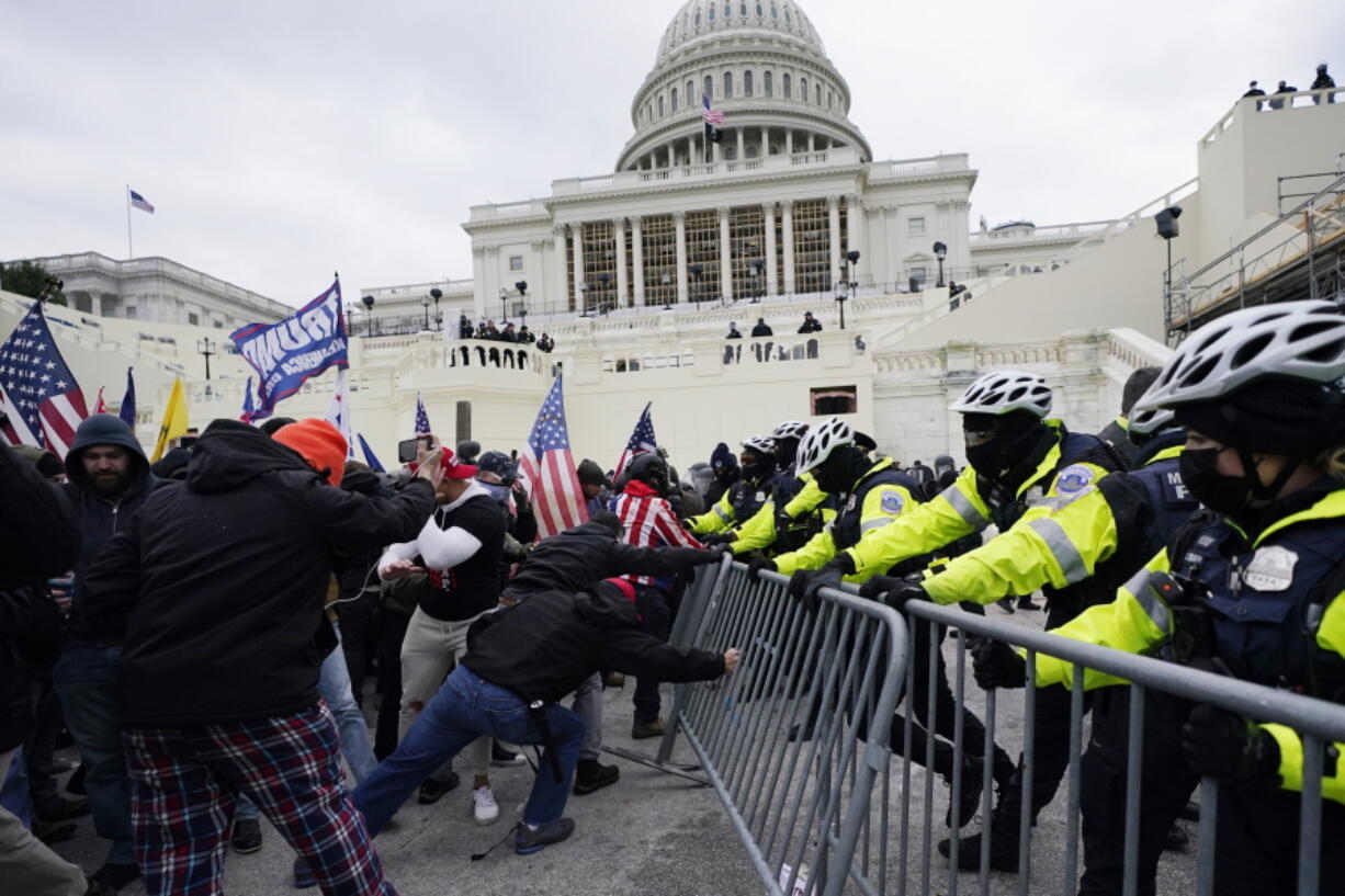 FILE - Violent insurrections loyal to President Donald Trump try to break through a police barrier at the Capitol in Washington on Jan. 6, 2021. Jennifer Leigh Ryan, a real estate agent from suburban Dallas who flaunted her participation in the Jan. 6 riot at the U.S. Capitol on social media and later bragged she wasn't going to jail because she is white, has blond hair and a good job was sentenced on Thursday, Nov. 4, to two months behind bars.