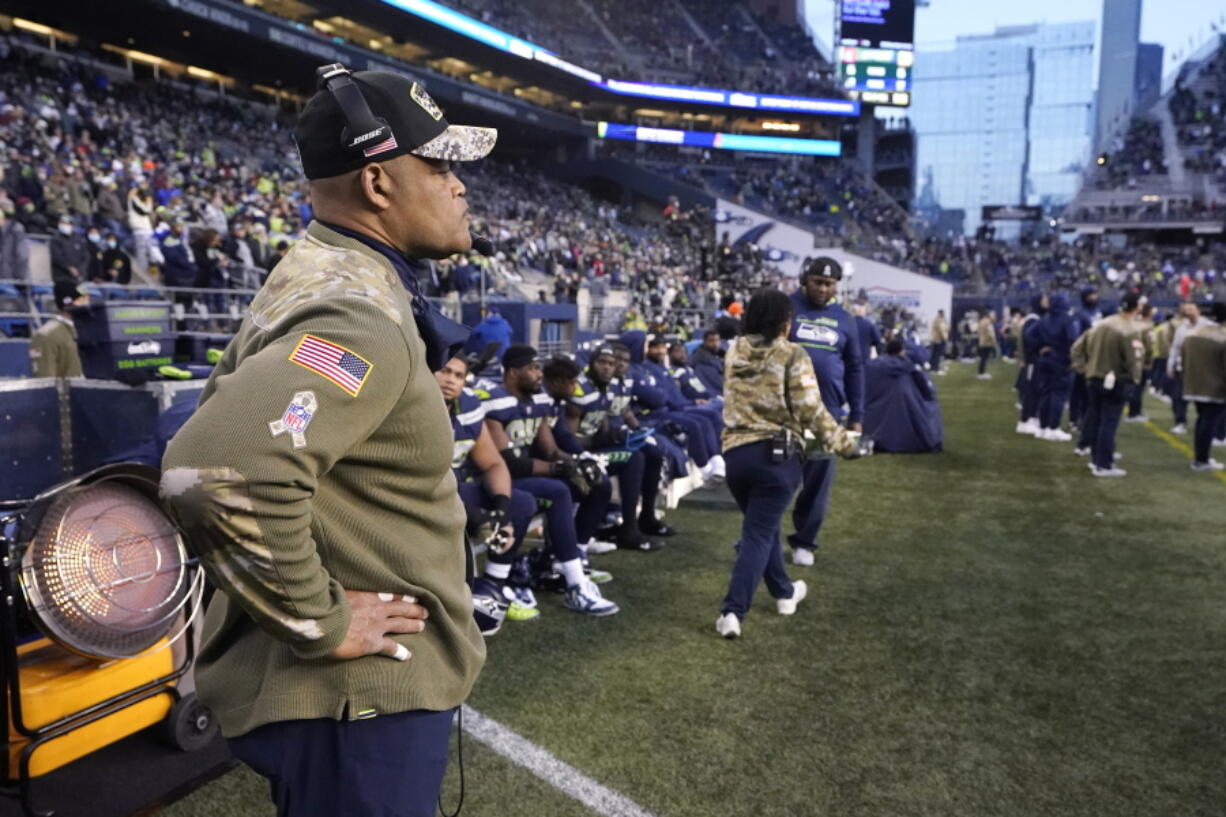 Seattle Seahawks defensive coordinator Ken Norton Jr., left, stands near the bench late in the second half against the Arizona Cardinals on Sunday. (Ted S.