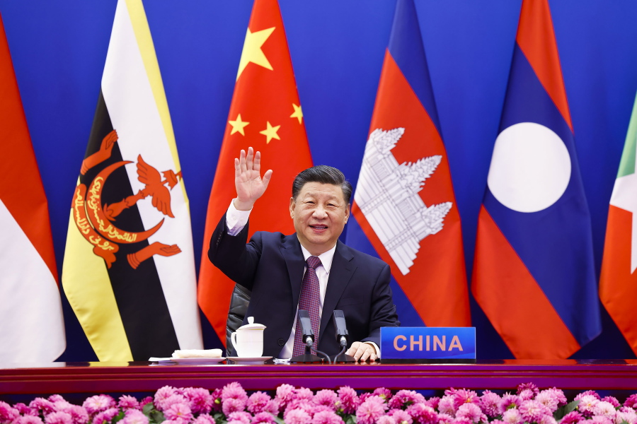 In this photo released by Xinhua News Agency, Chinese President Xi Jinping waves as he chairs the ASEAN-China Special Summit to commemorate the 30th Anniversary of ASEAN-China Dialogue Relations via video link from Beijing, China on Monday, Nov. 22, 2021. Xi on Monday said his country will not seek dominance over Southeast Asia or bully its smaller neighbors, amid ongoing friction over the South China Sea.
