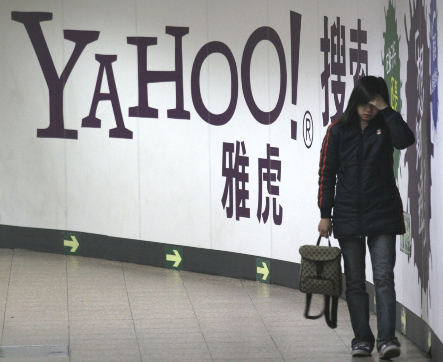 FILE - A woman walks past a Yahoo billboard in a Beijing subway in this March 17, 2006. Yahoo Inc. on Tuesday, Nov.