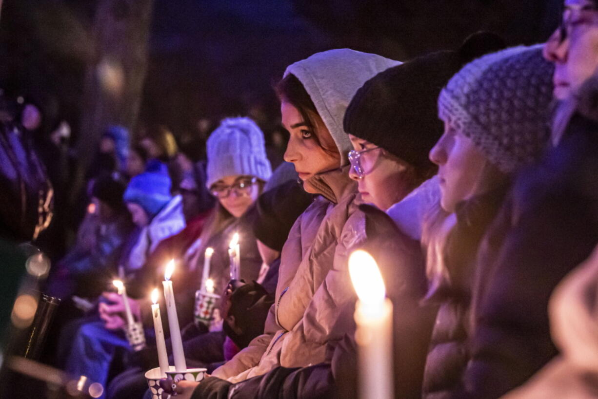 People gather in Waukesha's Cutler Park for a candlelight vigil  for those affected by the Waukesha Christmas Parade tragedy, Monday, Nov. 22, 2021 in Waukesha, Wis..