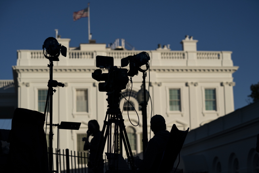 FILE - Journalists gather outside the White House in Washington on Nov. 4, 2020. President Joe Biden's $1.85 trillion social spending bill includes a provision that, if it becomes law, would mark the first time the federal government has offered targeted support to local news organizations. The help comes in the form of a payroll tax credit for companies that employ eligible local journalists.