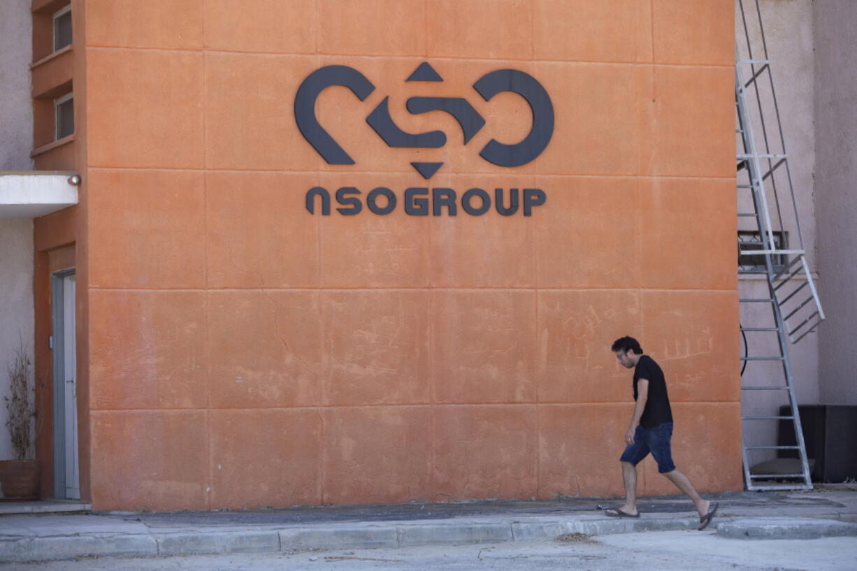 FILE - A logo adorns a wall on a branch of the Israeli NSO Group company, near the southern Israeli town of Sapir, Aug. 24, 2021. The cellphones of six Palestinian human rights activists were infected with spyware from the notorious Israeli hacker-for-hire company NSO Group as early as July 2020, a security researcher discovered just days before Israel's defense minister branded some of their employers terrorist organizations. It was the first time the military-grade Pegasus spyware was known to have been used against Palestinian civil society activists.
