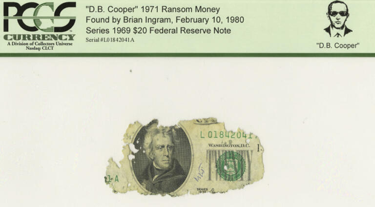 In this photo released by Heritage Auction Galleries June 13, 2008, a fragment of one of the fifteen tattered $20 bills recovered from the infamous 1971 D.B. Cooper skyjacking is shown.