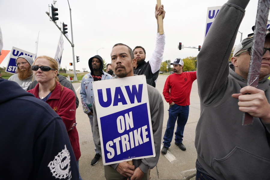 Members of the United Auto Workers listen to Agriculture Secretary Tom Vilsack speak outside of a John Deere plant, Wednesday, Oct. 20, 2021, in Ankeny, Iowa. About 10,000 UAW workers have gone on strike against John Deere since last Thursday at plants in Iowa, Illinois and Kansas.