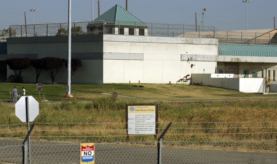 FILE - The Federal Correctional Institution is shown in Dublin, Calif., July 20, 2006. Nearly 100 federal Bureau of Prisons employees have been arrested, convicted or sentenced in criminal cases since the start of 2019, accused of crimes from smuggling drugs and weapons to stealing prison property, sexually assaulting inmates and murder. Those arrested include Ray Garcia, the warden at the Federal Correctional Institution at Dublin.