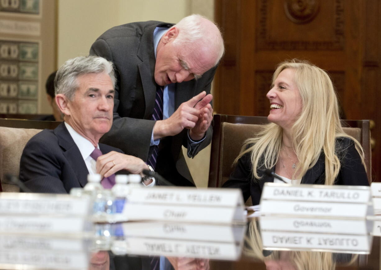 FILE - Federal Reserve Governors Jerome Powell, from left, Daniel Tarullo and Lael Brainard, talk before the start of a Federal Reserve System Board of Governors open meeting in Washington, Friday, June 3, 2016. President Joe Biden announced Monday, Nov. 22, 2021 that he's nominating Powell for a second term as Federal Reserve chair, endorsing his stewardship of the economy through a brutal pandemic recession in which the Fed's ultra-low rate policies helped bolster confidence and revitalize the job market. Biden also said he would nominate Brainard, the lone Democrat on the Fed's Board of Governors and the preferred alternative to Powell for many progressives, as Vice Chair.