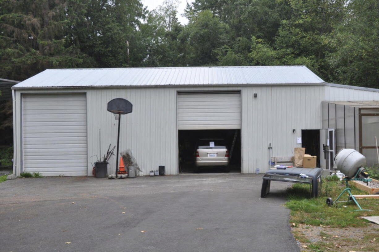In this photo provided by the U.S. Attorney's Office is the exterior of a workshop owned by Bradley Woolard, 42, who ran a significant fentanyl pill-pressing operation from the property in Arlington, Wash., on Aug. 16, 2018. Authorities said Woolard and his right-hand man, Anthony Pelayo, 35, of Marysville, Wash., had ordered enough supplies to make 2.5 million make around 2.5 million fentanyl-laced pills before they got caught in 2018. Woolard was sentenced to 20 years in prison on Tuesday, Nov. 30, 2021. Pelayo was sentenced to 15 years on Nov. 23, 2021. (Martin Weinbaum/Snohomish County Sheriff's/U.S.