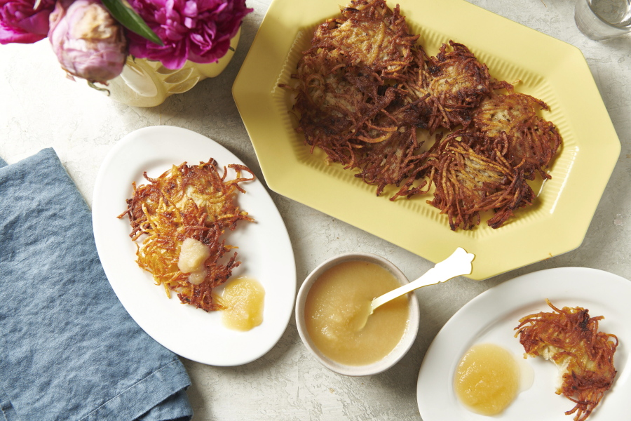 Plates of potato pancakes, or latkes, are displayed in New York in August 2020. Latkes are the food most traditionally associated with Hanukkah. There are all kinds of modern variations using other vegetables and other toppings. (Cheyenne M.