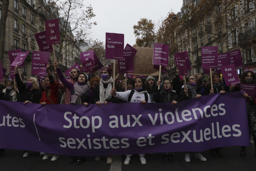 Women demonstration behind a banner reading "Stop to sexist and sexual violences" Saturday, Nov. 20, 2021 in Paris. Tens of thousands of protesters marched Saturday through Paris and other French cities to demand more government action to prevent violence against women. The demonstrations come amid growing outrage in France over women killed by their partners and as French women are increasingly speaking out about sexual harassment and abuse.