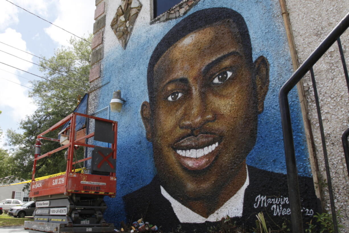 FILE - A painted mural of Ahmaud Arbery is displayed on May 17, 2020, in Brunswick, Ga., where the 25-year-old man was shot and killed in February.  Arbery was shot and killed by two men who told police they thought he was a burglar.