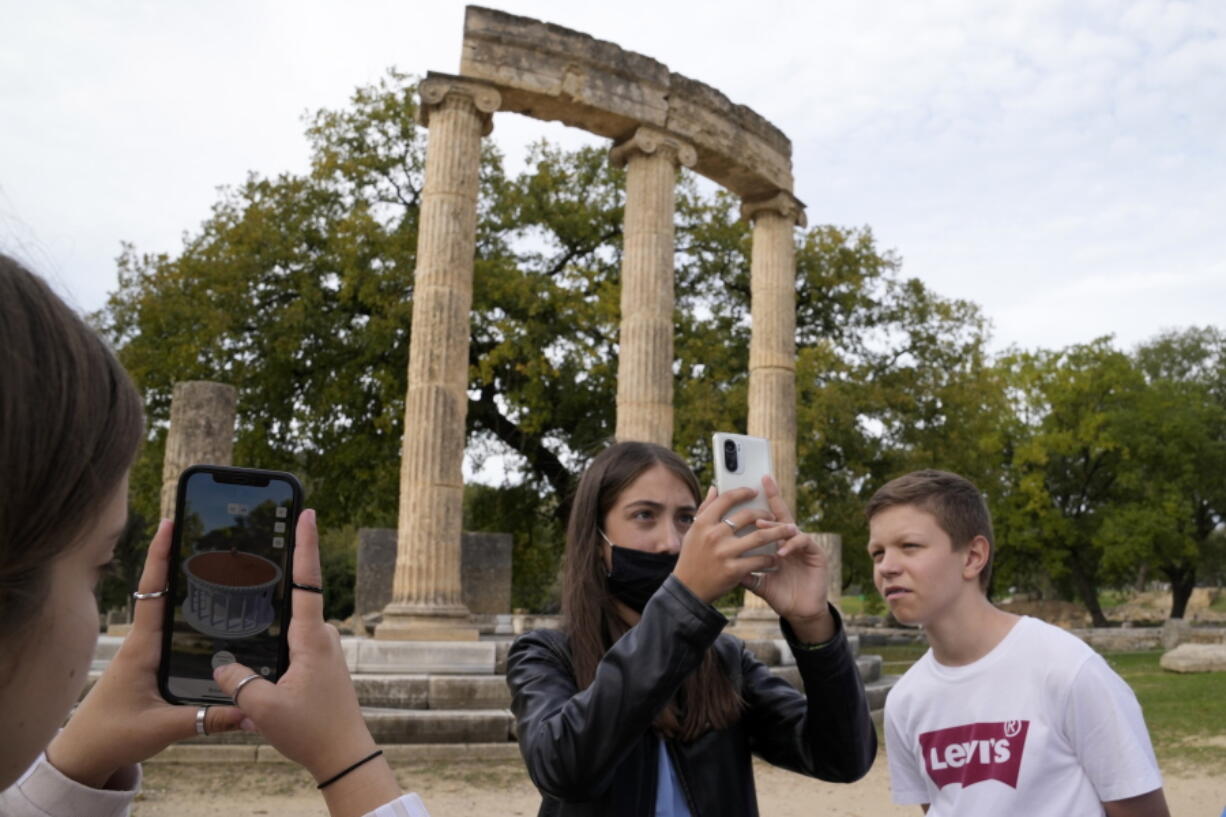 School students use a mobile app at the ancient site of Olympia, southwestern Greece, on Nov. 10.