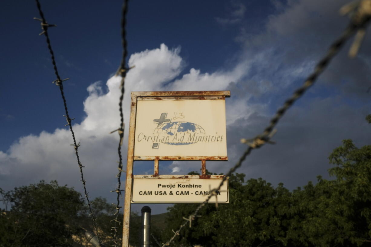 FILE - This Oct. 21, 2021, photo shows a sign outside Christian Aid Ministries in Titanyen, Haiti, which had 17 of their members kidnapped by the 400 Mawozo gang. Two of 17 abducted members of a missionary group have been freed in Haiti and are safe, "in good spirits and being cared for," their Ohio-based church organization, Christian Aid Ministries, announced Sunday, Nov. 21, 2021.