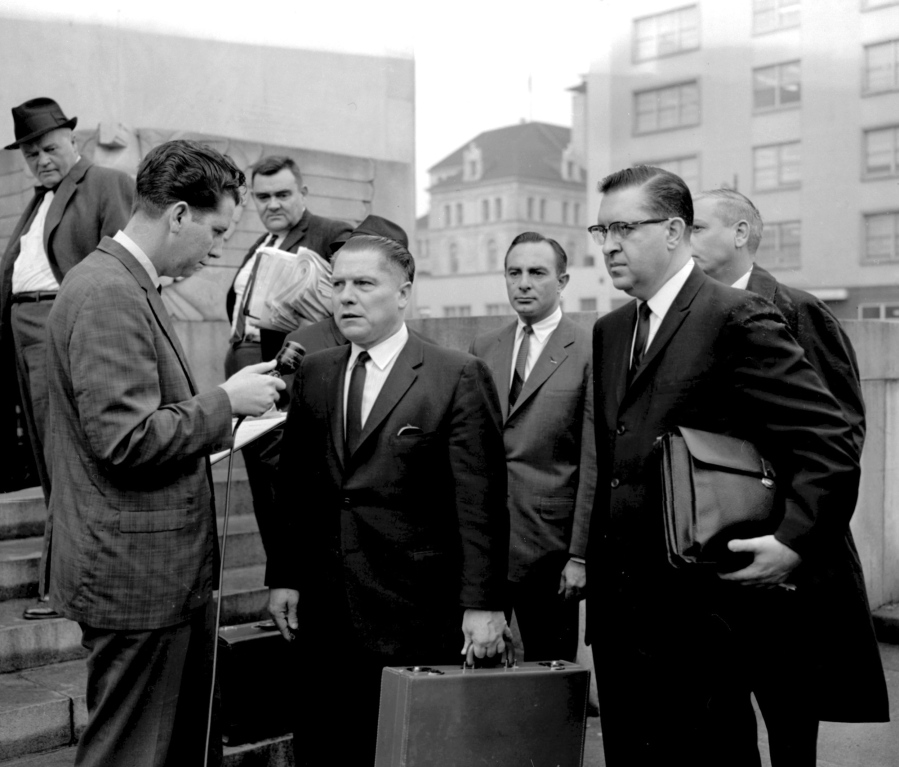 In this 1964 photo, a reporter questions Teamsters President Jimmy Hoffa outside the federal courthouse in Chattanooga, Tenn., during Hoffa's trial that ended in a jury tampering conviction. The decades-long odyssey to find the body of former Teamsters boss Jimmy Hoffa apparently has turned to a former New Jersey landfill below an elevated highway. The FBI obtained a search warrant to "conduct a site survey underneath the Pulaski Skyway," Mara Schneider, a spokeswoman for the Detroit field office, said in a written statement Friday, Nov. 19, 2021.