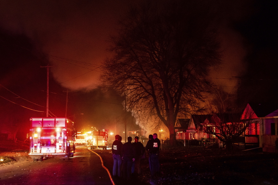 Emergency personnel are shown at the scene of a fire and explosion at a home in Flint, Mich., Monday night, Nov. 22, 2021. Three people were missing following the fire and explosion, authorities said.